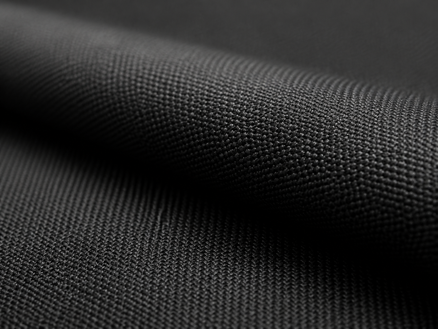 Macro study of tightly woven charcoal nylon fabric
