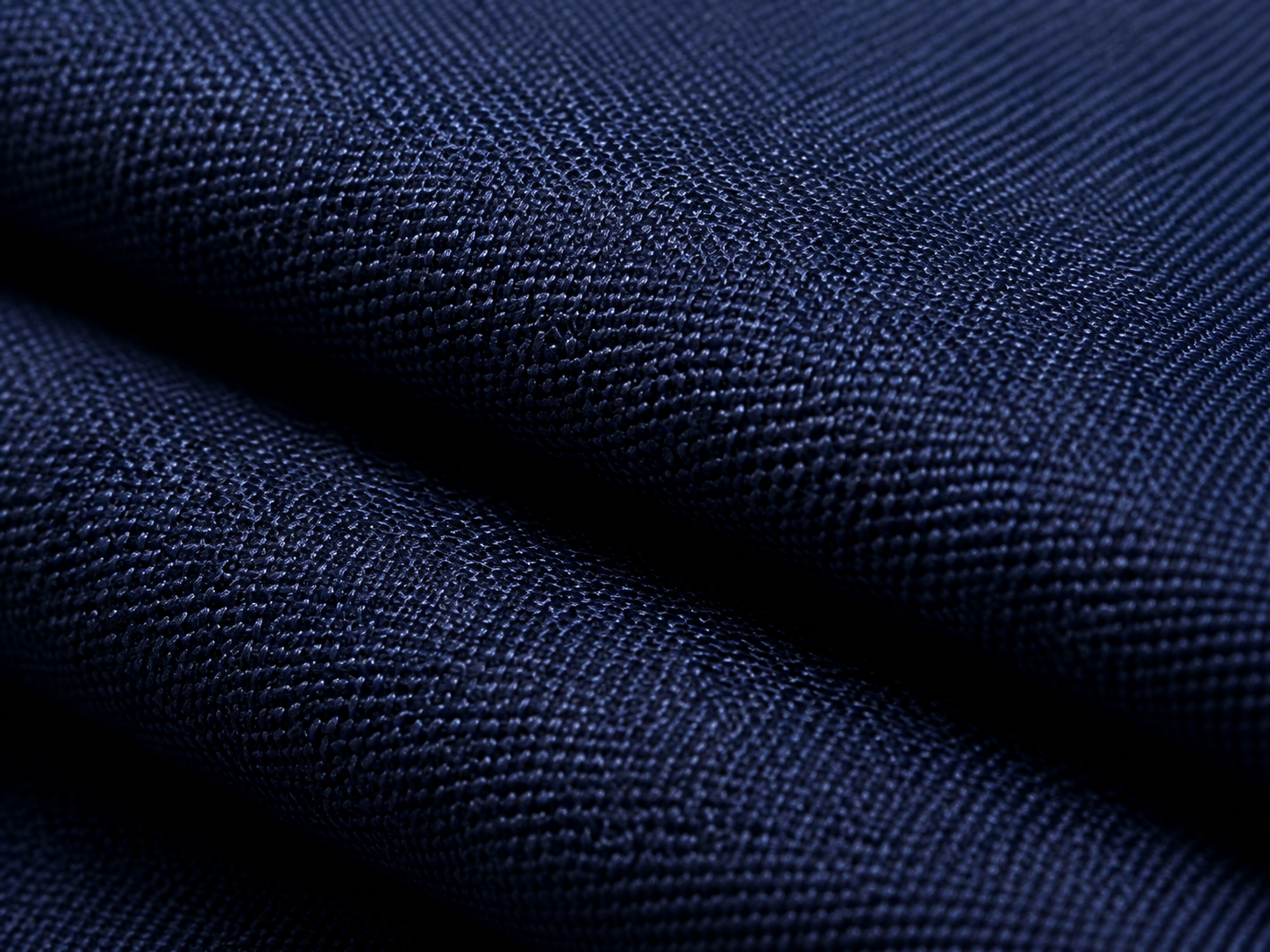 Macro study of a folded navy woven polyester fabric