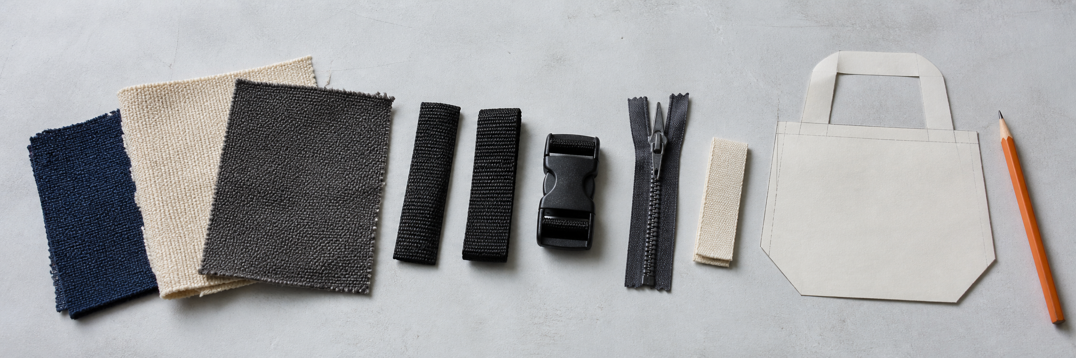 Woven fabric swatches, webbing, a buckle, zipper and paper bag pattern arranged for a quotation brief