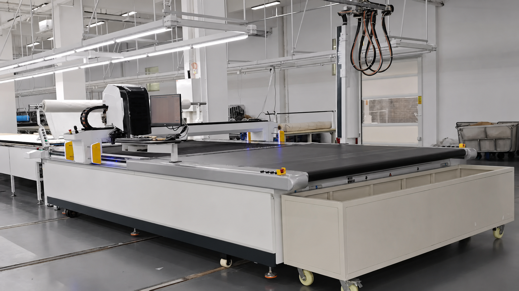 Computer-controlled textile cutting table in a clean factory workshop