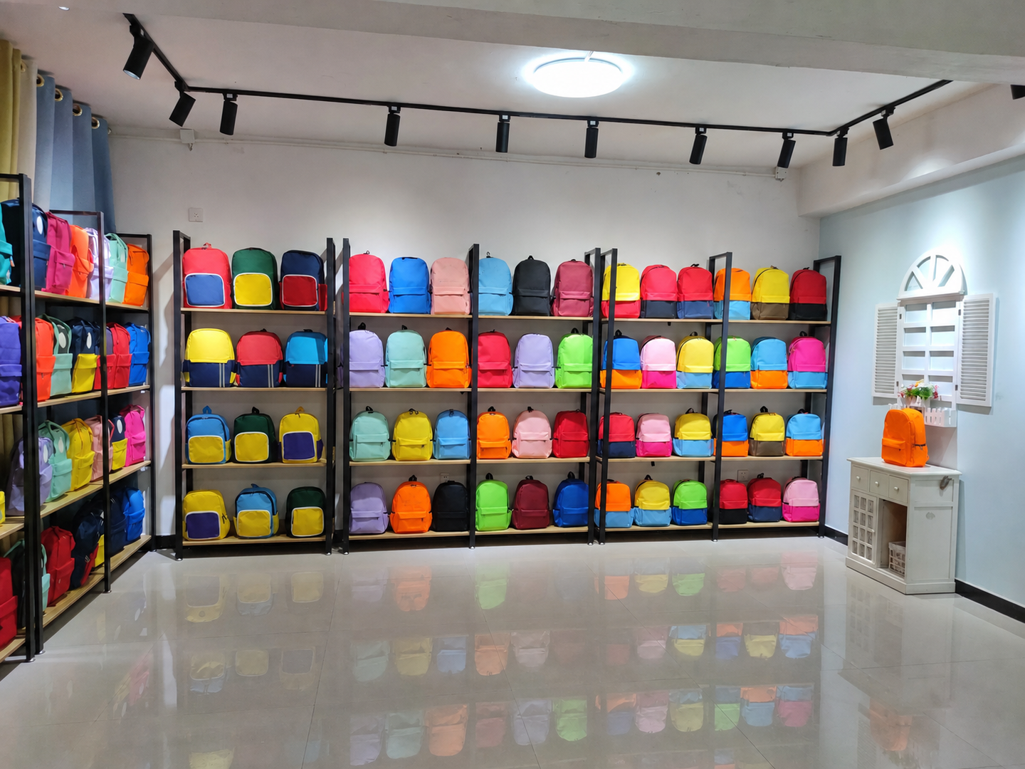 Colorful school backpack samples displayed on shelving